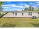 Home exterior featuring brick foundation, air conditioning and manicured lawn at 162 E Abbey Ct, Smithfield, NC 27577