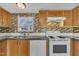 Kitchen featuring appliances and wood cabinets with backsplash at 162 E Abbey Ct, Smithfield, NC 27577