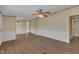 Open living room featuring laminate flooring, fresh neutral paint, and a dining area with a chandelier at 162 E Abbey Ct, Smithfield, NC 27577