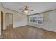 Comfortable living room featuring laminate flooring, fresh neutral paint, and sunlit windows and ceiling fan at 162 E Abbey Ct, Smithfield, NC 27577