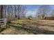 Expansive backyard with lush green grass and a charming white fence, great for outdoor activities at 1635 Sandy Cross Rd, Burlington, NC 27217