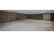 Unfinished basement with brick walls and cement floor, offering ample space at 1635 Sandy Cross Rd, Burlington, NC 27217