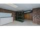Spacious basement featuring brick walls, open shelving, and ample storage space at 1635 Sandy Cross Rd, Burlington, NC 27217