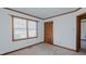 Bedroom with carpet, closet, window, and wood trim on the ceiling and baseboards at 1635 Sandy Cross Rd, Burlington, NC 27217