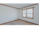 Bright bedroom with neutral carpet, white walls, wood trim and window letting in natural light at 1635 Sandy Cross Rd, Burlington, NC 27217