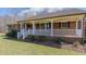 Charming red brick ranch-style home with white front porch and a well-maintained landscape at 1635 Sandy Cross Rd, Burlington, NC 27217