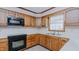 Kitchen area featuring wooden cabinets, neutral countertops, and updated appliances at 1635 Sandy Cross Rd, Burlington, NC 27217