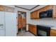 Well-lit kitchen featuring classic wooden cabinets and modern appliances at 1635 Sandy Cross Rd, Burlington, NC 27217