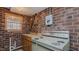 Basement kitchenette with vintage stove and sink and unique brick walls at 1635 Sandy Cross Rd, Burlington, NC 27217