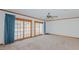 Spacious living room with large sliding glass doors, bright light, and neutral carpet at 1635 Sandy Cross Rd, Burlington, NC 27217