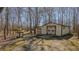 Large outbuilding with double doors, plus a smaller outbuilding, in a wooded setting at 1635 Sandy Cross Rd, Burlington, NC 27217