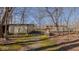 View of small outbuildings nestled among trees on this wooded property at 1635 Sandy Cross Rd, Burlington, NC 27217