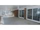 Bright sunroom featuring white ceilings and walls, brick accents, and backyard views at 1635 Sandy Cross Rd, Burlington, NC 27217