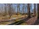 Scenic view of treed lot with walking path to outbuildings at 1635 Sandy Cross Rd, Burlington, NC 27217