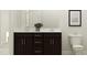 Modern bathroom featuring a double sink vanity with dark cabinetry and a stylish plant at 189 Tennyson Dr # 236, Garner, NC 27529