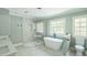 Bright bathroom showcasing a modern shower, free-standing tub, and double windows for natural light at 1900 High Oaks Ln, Raleigh, NC 27606
