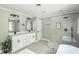 Bathroom featuring a double vanity with modern fixtures and a sleek glass-enclosed shower at 1900 High Oaks Ln, Raleigh, NC 27606