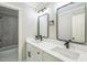 Bathroom featuring double sinks with quartz countertops, modern fixtures, and a shower-tub combo at 1900 High Oaks Ln, Raleigh, NC 27606
