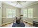 Bedroom with a drum set positioned near windows, hardwood flooring, and natural light at 1900 High Oaks Ln, Raleigh, NC 27606