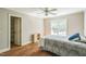 Bedroom with hardwood floors, ceiling fan, and an open closet at 1900 High Oaks Ln, Raleigh, NC 27606