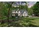 Charming home featuring beautiful landscaping, a spacious front porch, and abundant natural light from many windows at 1900 High Oaks Ln, Raleigh, NC 27606