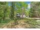 Attractive two-story brick home with a covered front porch and long driveway surrounded by trees at 1900 High Oaks Ln, Raleigh, NC 27606