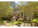 Rear exterior of the house featuring a deck with stairs and a neatly landscaped yard at 1900 High Oaks Ln, Raleigh, NC 27606