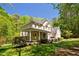 Charming two-story brick home with a welcoming porch and lush landscaping at 1900 High Oaks Ln, Raleigh, NC 27606