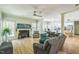 Open-concept living room with a fireplace, and views of the kitchen and adjacent dining area at 1900 High Oaks Ln, Raleigh, NC 27606