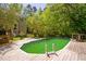 Backyard pool surrounded by a wooden deck and lush greenery, perfect for relaxation and entertainment at 1900 High Oaks Ln, Raleigh, NC 27606