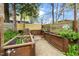 Outdoor raised garden beds with brick pathway, surrounded by a wooden fence provides a dedicated space for gardening at 200 Lincoln Ct, Raleigh, NC 27610