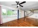 Spacious living room with hardwood floors, large windows, and access to the front porch and staircase at 200 Lincoln Ct, Raleigh, NC 27610