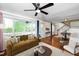 Sun-filled living room with stylish decor, a cozy sofa, and a staircase at 200 Lincoln Ct, Raleigh, NC 27610