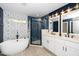 Bathroom includes a modern shower, double vanity and soaking tub at 200 Lincoln Ct, Raleigh, NC 27610