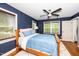 Bedroom with hardwood floors, a ceiling fan, and ample natural light at 200 Lincoln Ct, Raleigh, NC 27610