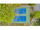 Aerial view of well-maintained tennis courts surrounded by green trees at 200 Lincoln Ct, Raleigh, NC 27610