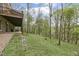 Spacious backyard features a tiered deck, lush greenery, and a tranquil creek flowing through the landscape at 2004 Riverview Dr, Clayton, NC 27527