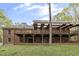 Back of the house featuring a large deck with a pergola and a green, grassy yard at 2004 Riverview Dr, Clayton, NC 27527