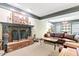 Finished basement featuring a brick fireplace, leather sofa, and custom trim work at 2004 Riverview Dr, Clayton, NC 27527
