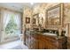 Bathroom features a double vanity sink, floral wallpaper, and bright window views at 2004 Riverview Dr, Clayton, NC 27527