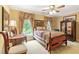 Charming bedroom with decorative bedding, window views, and antique furniture pieces at 2004 Riverview Dr, Clayton, NC 27527