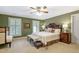 Cozy bedroom with a king-sized bed, shuttered windows, and hardwood accents at 2004 Riverview Dr, Clayton, NC 27527