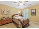 Cozy bedroom featuring a wooden bed frame, warm yellow walls, and a ceiling fan for added comfort at 2004 Riverview Dr, Clayton, NC 27527