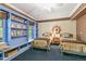 Nautical themed bedroom featuring built-in shelving, two twin beds and a ceiling fan at 2004 Riverview Dr, Clayton, NC 27527