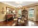 Formal dining room boasts hardwood floors, elegant chandelier, and large windows at 2004 Riverview Dr, Clayton, NC 27527