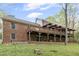 Back exterior view of large brick home featuring multiple decks and a covered patio at 2004 Riverview Dr, Clayton, NC 27527