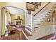 Grand foyer showcases dark hardwood floors, elegant staircase, and arched entry to the living room at 2004 Riverview Dr, Clayton, NC 27527