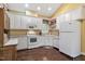Functional kitchen featuring white cabinets, modern appliances, and a bright window over the sink at 2004 Riverview Dr, Clayton, NC 27527