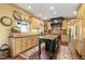 Charming kitchen with custom wood cabinets, contrasting island, and stainless steel appliances at 2004 Riverview Dr, Clayton, NC 27527