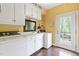Well-lit laundry room with white cabinetry, a sink, washer, dryer, and access to the outdoors at 2004 Riverview Dr, Clayton, NC 27527